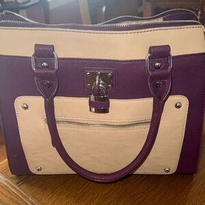Burgundy and tan handbag with front and back pocket.